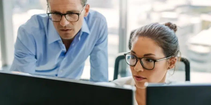 Business owner helping his employee to create TEM RFP scorecard