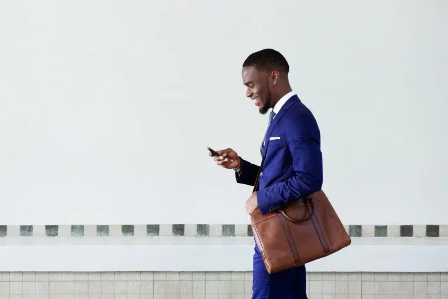 Business owner in suit checking his phone
