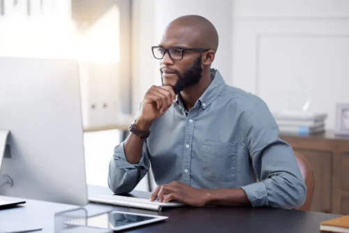 Guy in office checking SaaS spend management and how to reduce it
