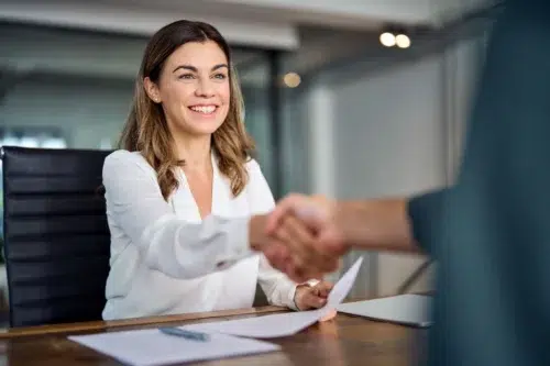 Woman doing handshake with new SaaS vendor management company - Calero