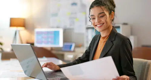 SaaS contract management review by woman on her laptop in the office